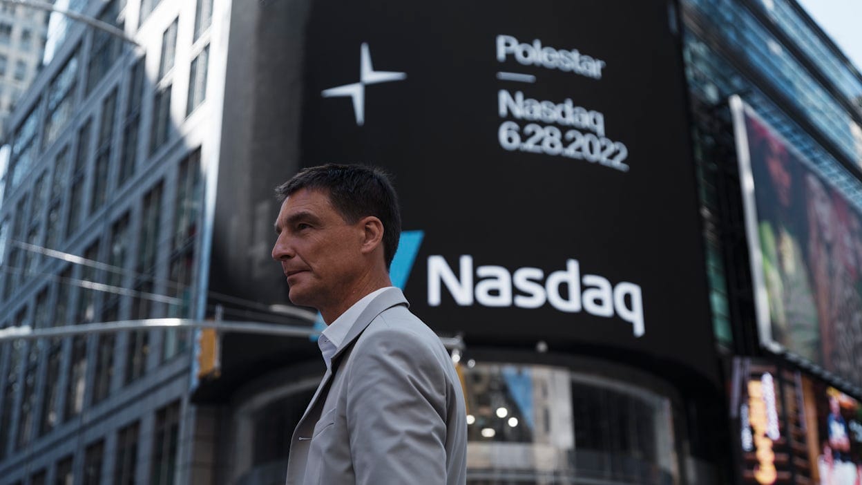 Thomas Ingenlath standing next to a big Polestar, Nasdaq billboard in New York.