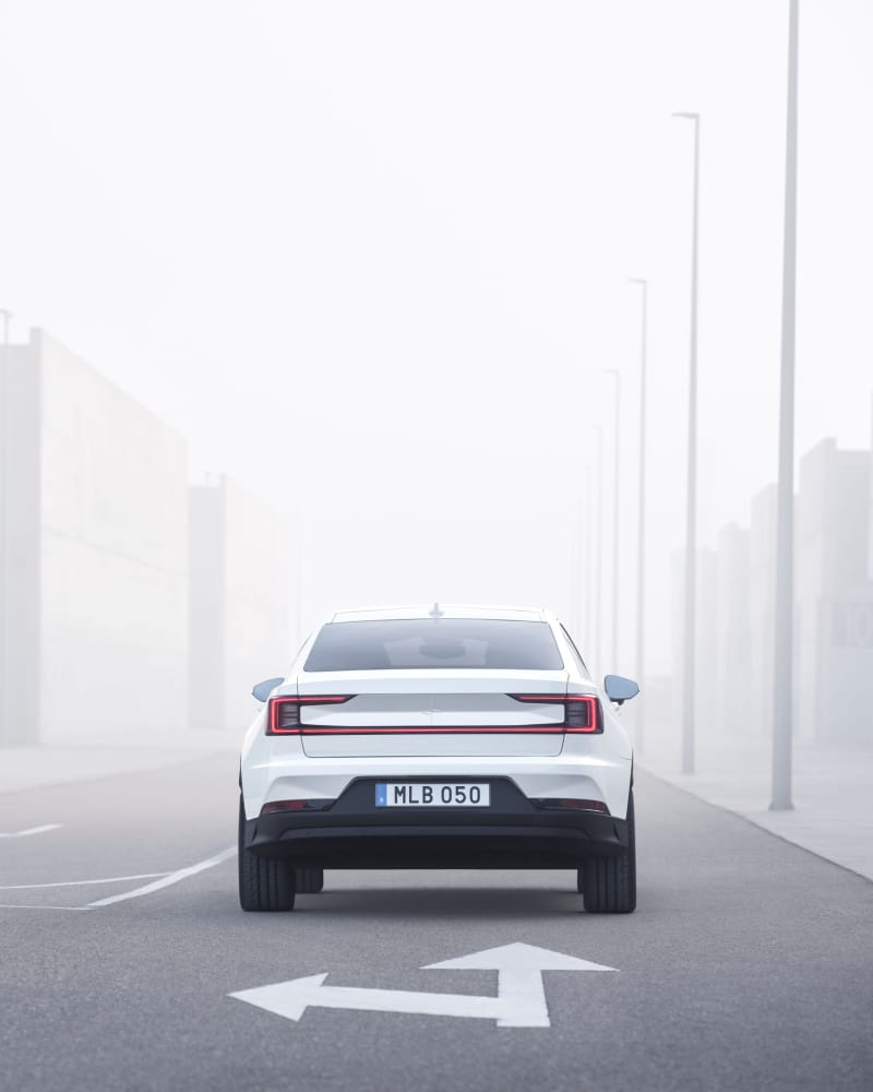 Polestar 2 drives forward on a road in a foggy environment