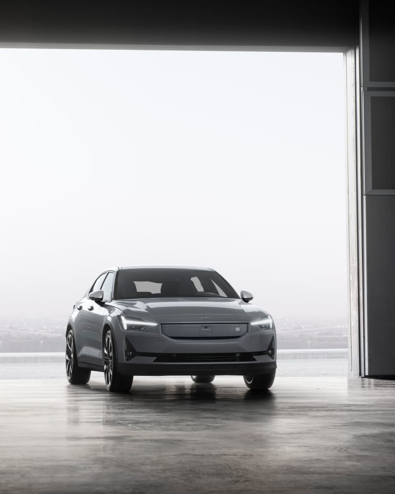 Polestar 2 rolls into a garage with a foggy background behind the car