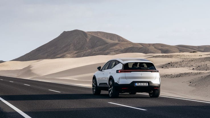 White Polestar 3 driving on a road in the desert.