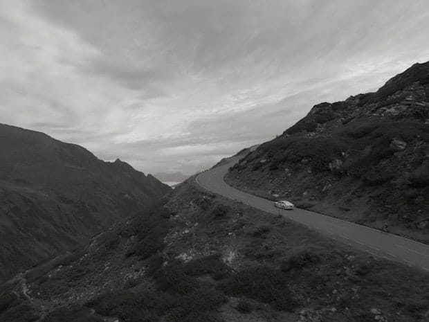 Bird eye view of a Polestar Precept in motion on a road in the hills