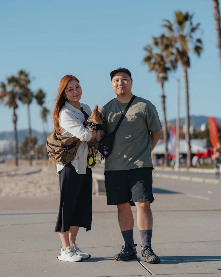 James Hou, his wife Aki and their yorkshire terrier Kuma posing for a photo at Ocean Park, Santa Monica.