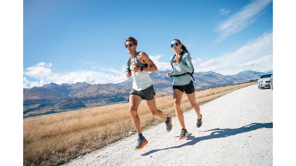 Cam and Lana running on a gravel road