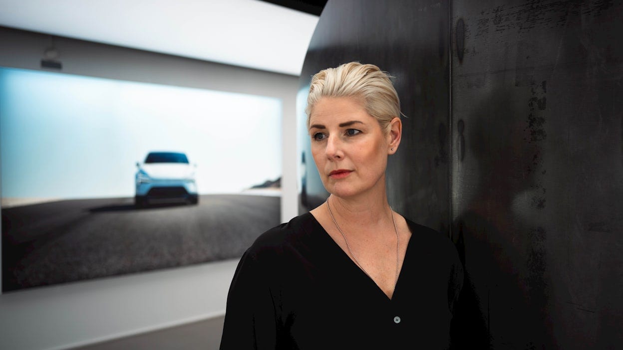 Linda Skogsberg standing in front of picture of Polestar 4