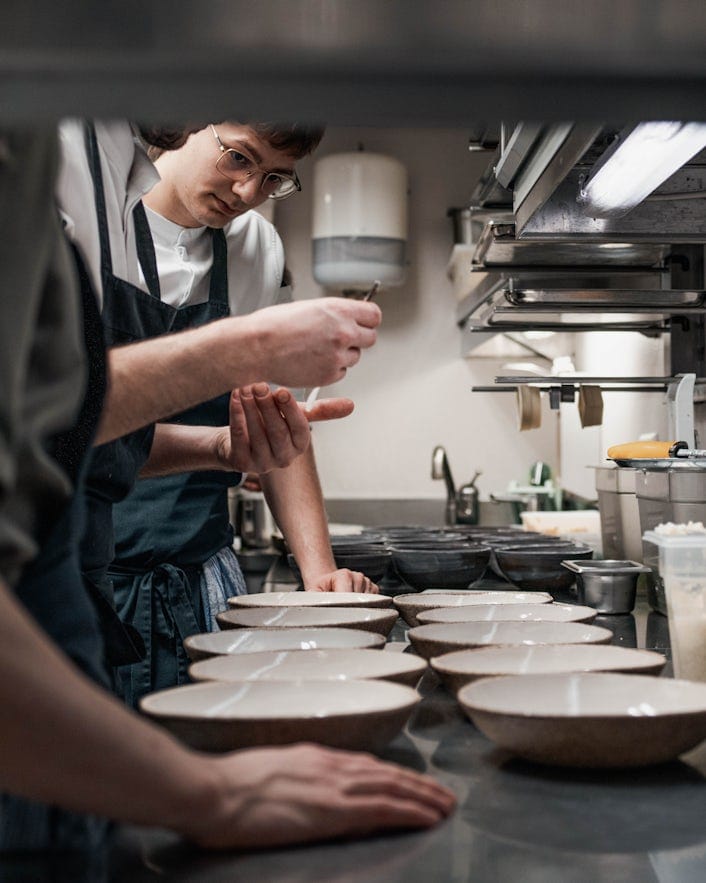 Chefs plating dishes in the kitchen